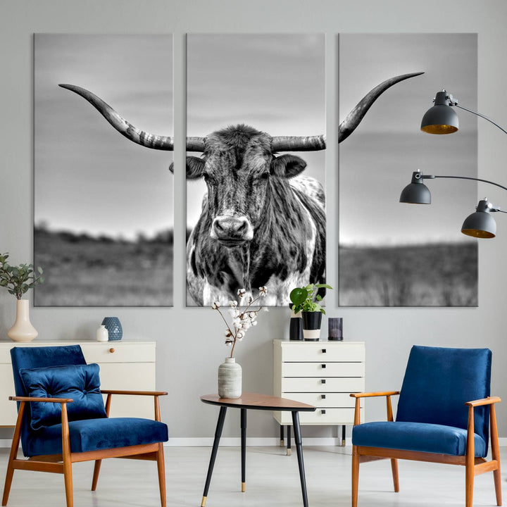 The Texas Longhorn Cow wall art, divided into three panels, is of gallery quality and displayed on a dark wall.