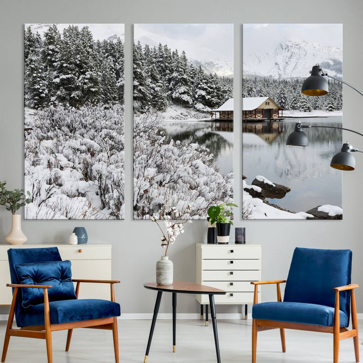 Experience the beauty of winter with the "Cabin by the Lake Canvas Wall Art," showcasing a serene snowy landscape. This rustic nature decor features a cozy cabin nestled amid snow-laden trees, set against a breathtaking mountain view, perfect for enhancing your living room.