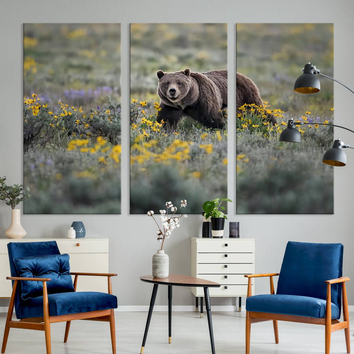 The "Grizzly 399 in Wild Flowers Wall Art Canvas Print" features a grizzly bear strolling through a field of yellow and purple flowers, beautifully showcased as a triptych. This handcrafted piece, proudly made in the USA, adds charm and sophistication to your space.