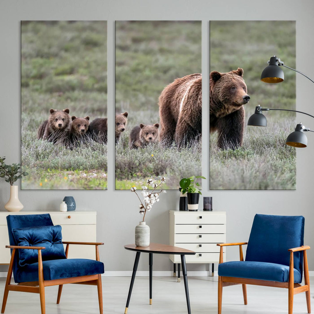 The large canvas print titled "Queen of the Tetons, 399 Grizzly Bear Cubs" showcases majestic wildlife photography of a bear and her cubs walking through the grass. This stunning canvas wall art, handmade in the USA, adds a charming touch to any room with its rustic decor appeal.