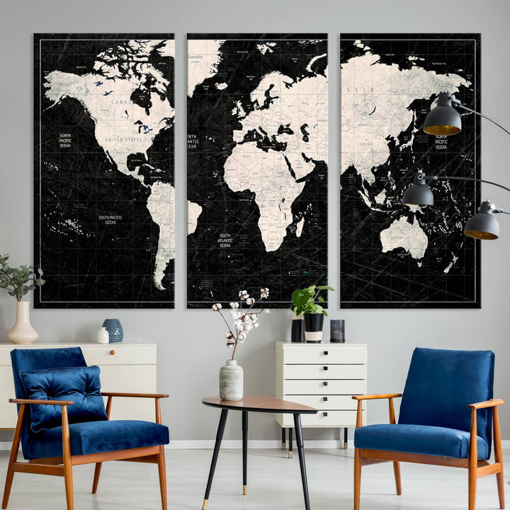 A bold global style framed black and white world map canvas print, presented in three panels, perfect for modern home or office decor.