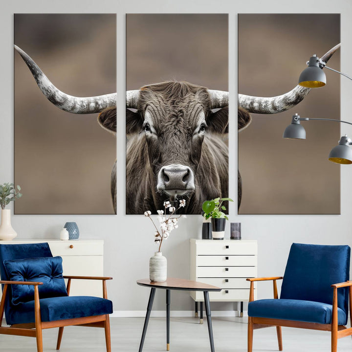 A close-up of a longhorn bull facing forward is featured in the Framed Texas Test-1, set against a blurred brown background.