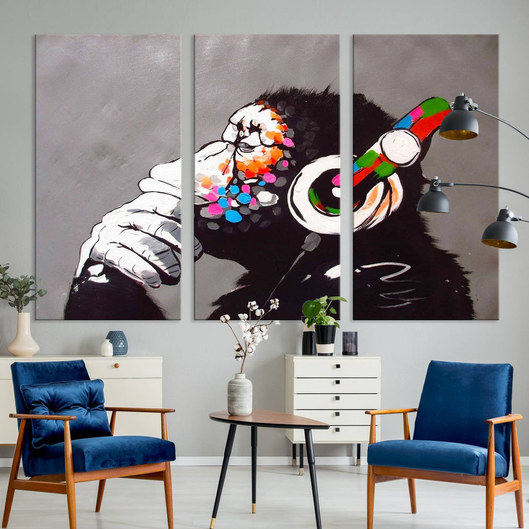 A vibrant triptych, the "DJ Monkey Listening to Music" wall art print, features a Banksy-inspired large canvas adorned with colorful modern pop art. This striking piece elegantly enhances the room with its dynamic and lively depiction.