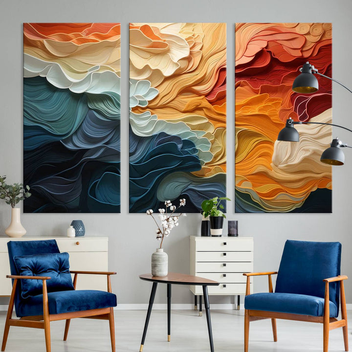 A Blue Orange Abstract Wave Wall Art Canvas Print adorns the wall. This colorful masterpiece is professionally hand-assembled to enhance any space.