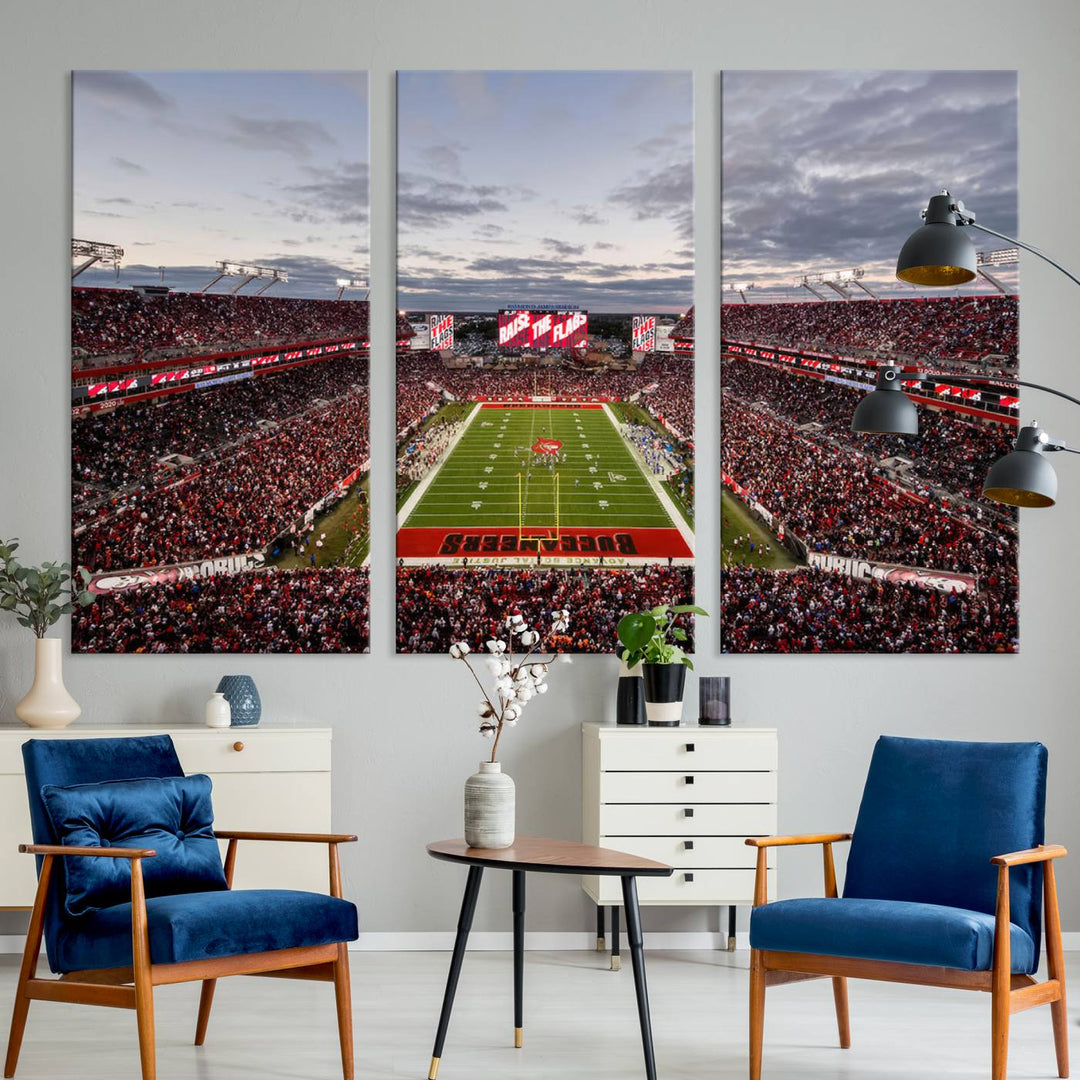 The wall art captures a stunning scene of Raymond James Stadium bathed in the warm hues of sunset. The sky, filled with clouds, provides a dramatic contrast to the vibrant lighting on the field, encapsulating the dynamic energy of a football game.