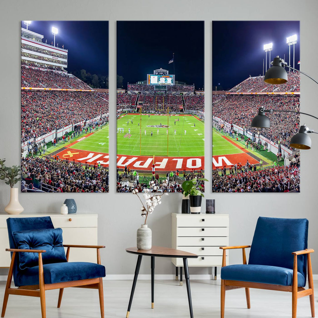 A NC State Wolfpack Football Team print of Carter-Finley Stadium at night features WOLFPACK illuminated brightly in the end zone grass.