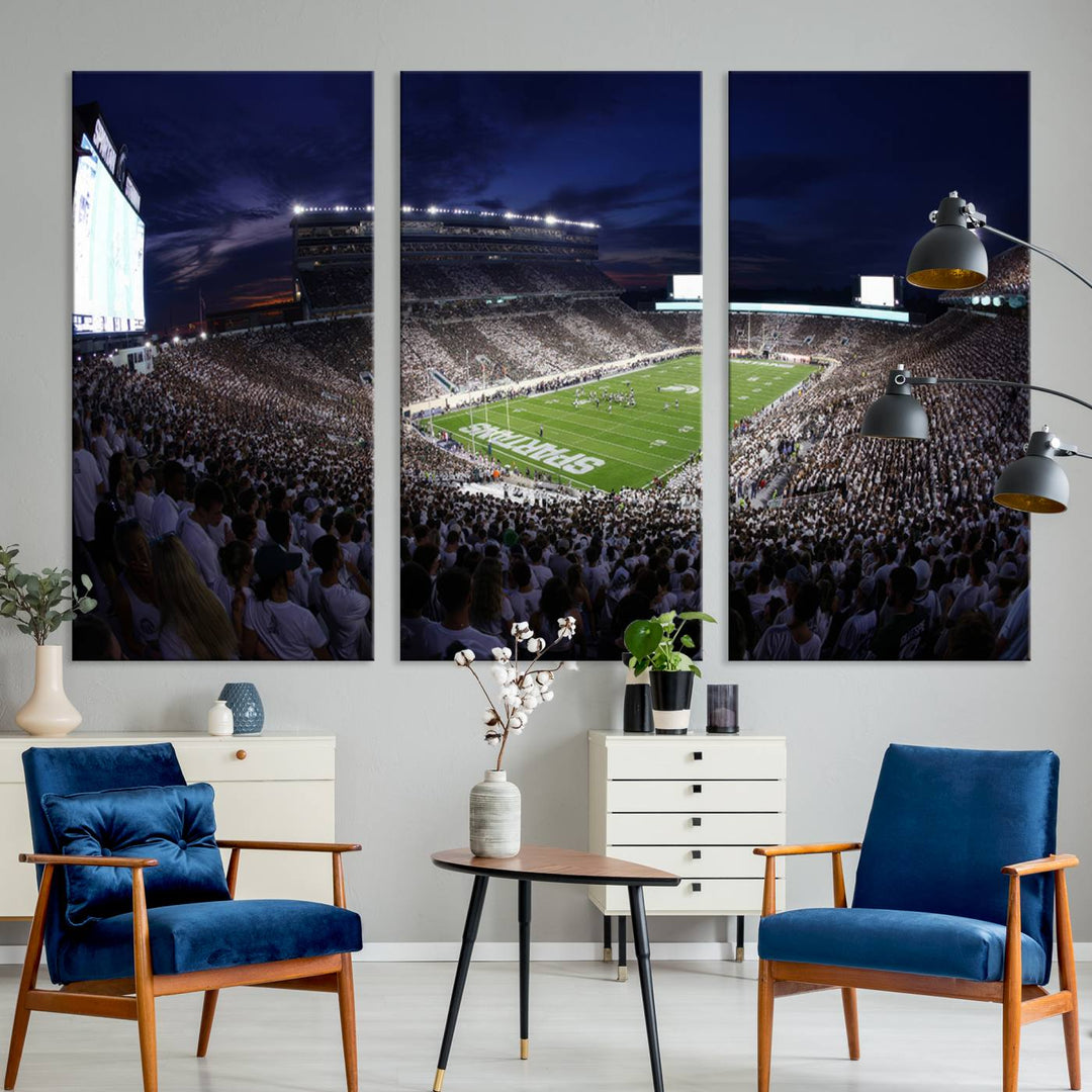 A packed football stadium at night, with bright lights and fans in white, depicted in a Michigan State Spartans Stadium wall art.