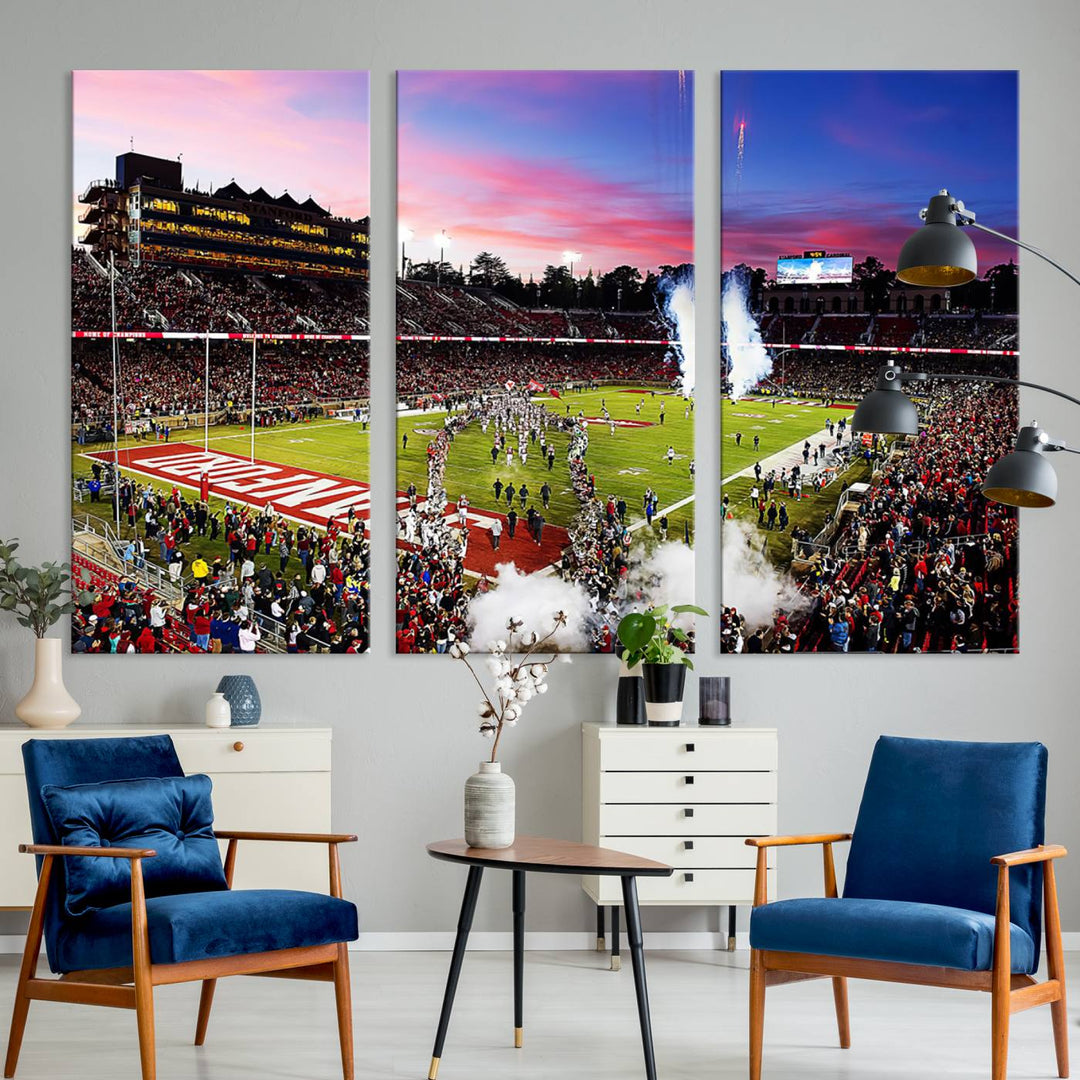 The wall art features a canvas print of the Stanford Cardinal football team, capturing players, fireworks, and smoke against the backdrop of a sunset at Stanford Stadium.