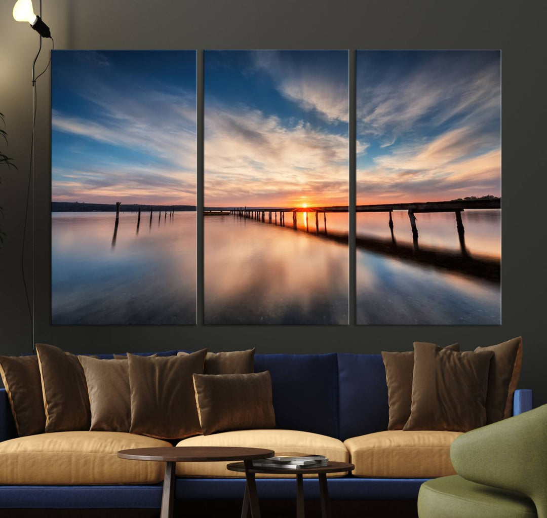 The Sunset Pier Canvas features a serene coastal landscape with vibrant hues under cloudy skies, ideal for modern decor.