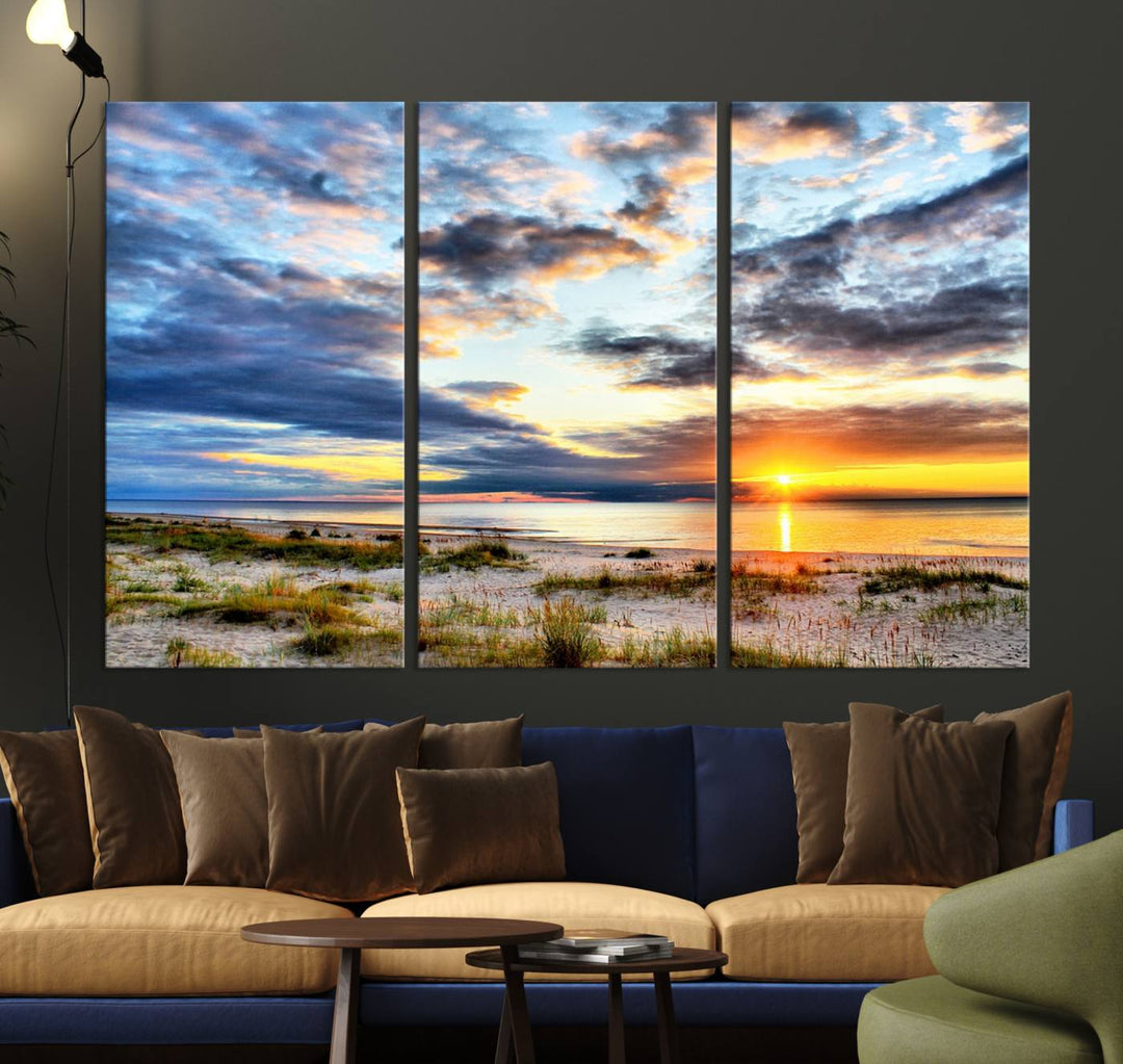 The Sunset On The Ocean canvas wall art features a beautiful beach sunset with grass and clouds.