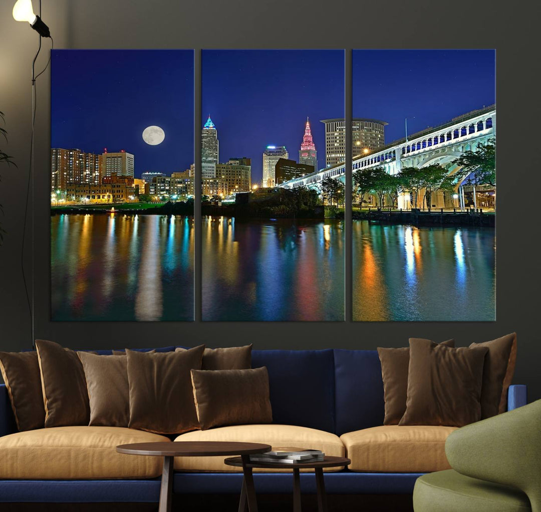 Cleveland City Lights Night Skyline Wall Art canvas showcases a moonlit cityscape reflected on water.