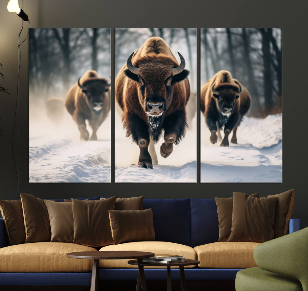 Wall art titled Cow Bighorn shows three bison running through snow in a forest.