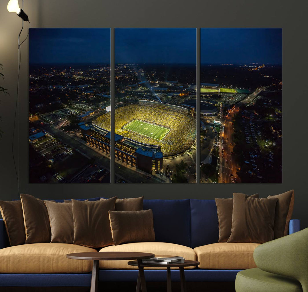 Aerial view of Michigan Stadium at night, surrounded by city lights, depicted on a Michigan Wolverines wall art canvas print.