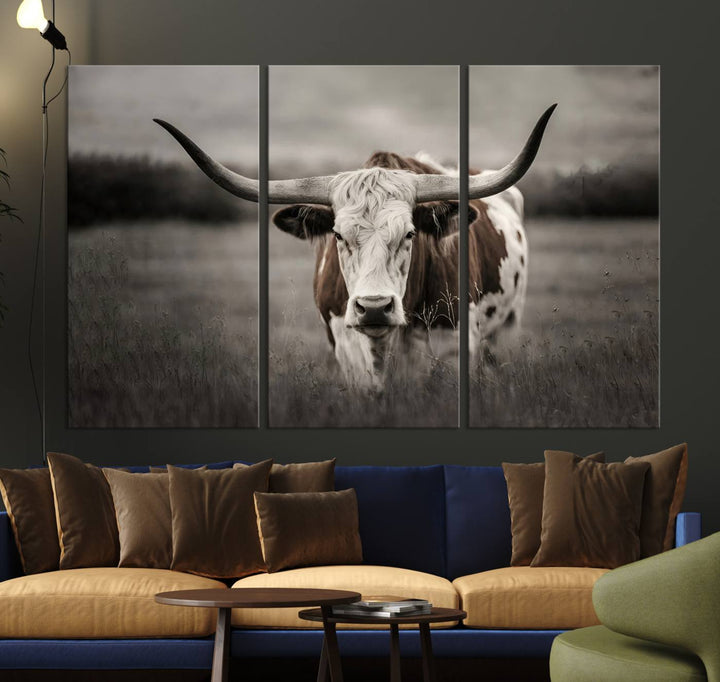 The Texas Longhorn Cow Canvas Wall Art Print adds a rustic touch to a living room.