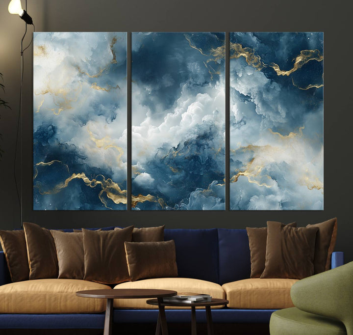 Modern living room featuring the Large Abstract Print - Luxe Blue and Gold Abstract Canvas Wall Art that showcases a bold cloudscape, perfect for modern home decor.