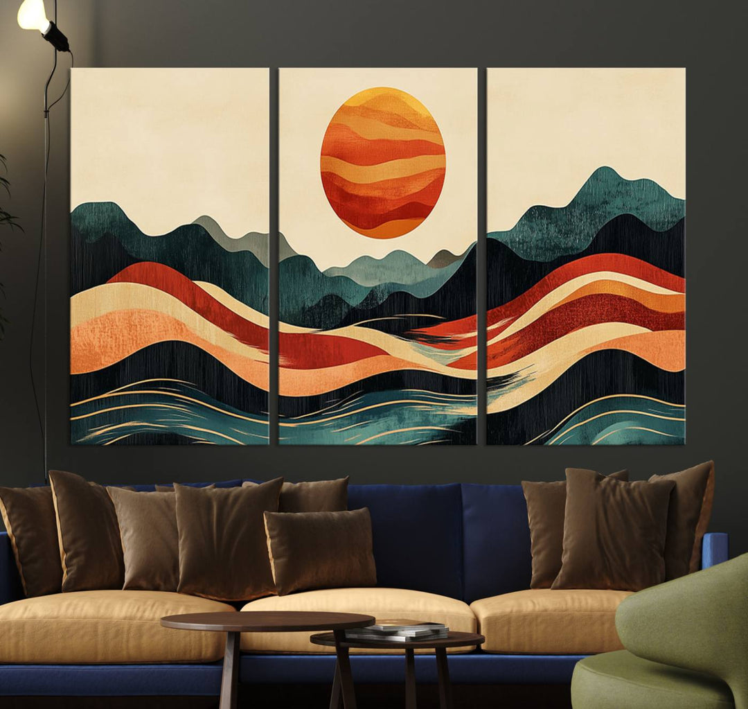 The Mountain Triptych wall art, featuring a design of the sun, mountains, and waves, is displayed prominently on the wall.