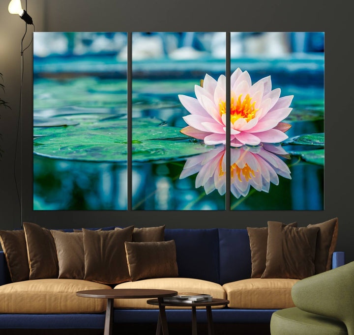 The Lotus Flower Canvas Print showcases a pink water lily with a yellow center gracefully floating on a calm pond.