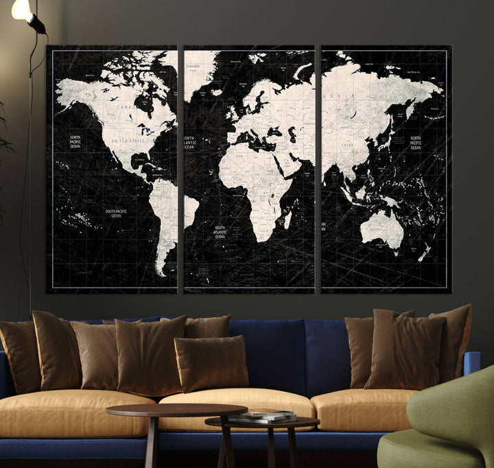 A bold global style framed black and white world map canvas print, presented in three panels, perfect for modern home or office decor.