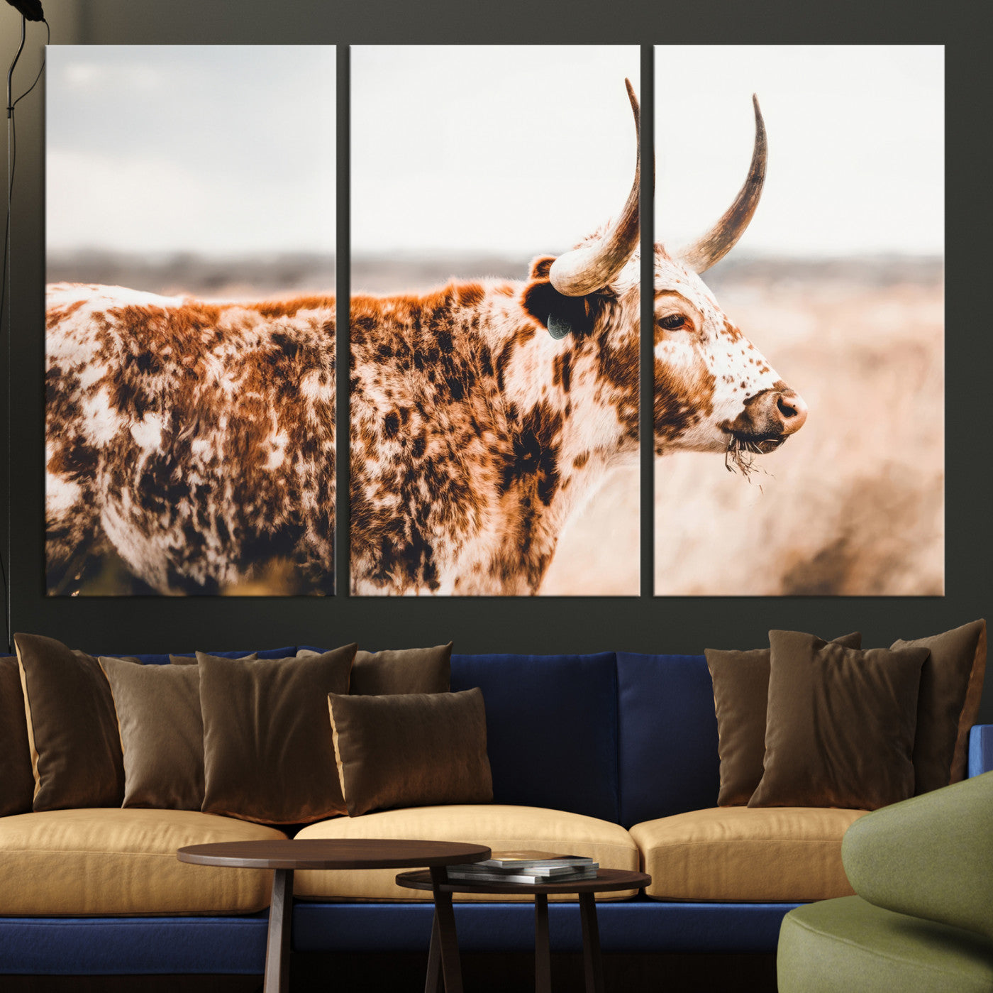 Speckled Texas longhorn with curved horns standing in a warm-toned prairie, perfect for rustic or country-style home decor.