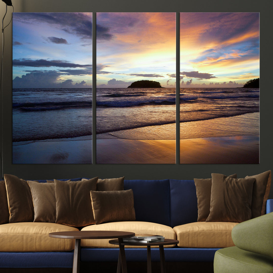 A tropical beach at sunset with waves gently washing ashore, reflecting golden and purple hues in the sky, creating a tranquil coastal scene.