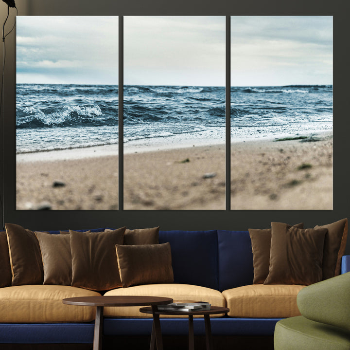 A moody ocean scene with gentle waves washing onto a sandy beach under a cloudy sky, creating a peaceful and coastal atmosphere.