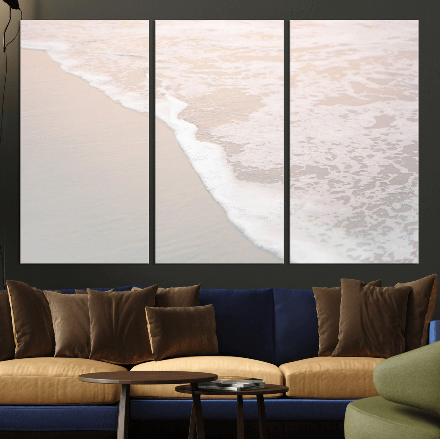 Close-up view of gentle ocean waves washing over smooth, wet sandy beach with soft foam along the shoreline.