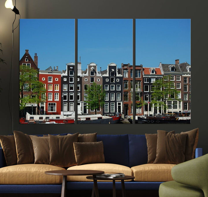 The Amsterdam City Wall Art Canvas Print showcases colorful traditional canal houses and boats set against a clear blue sky.