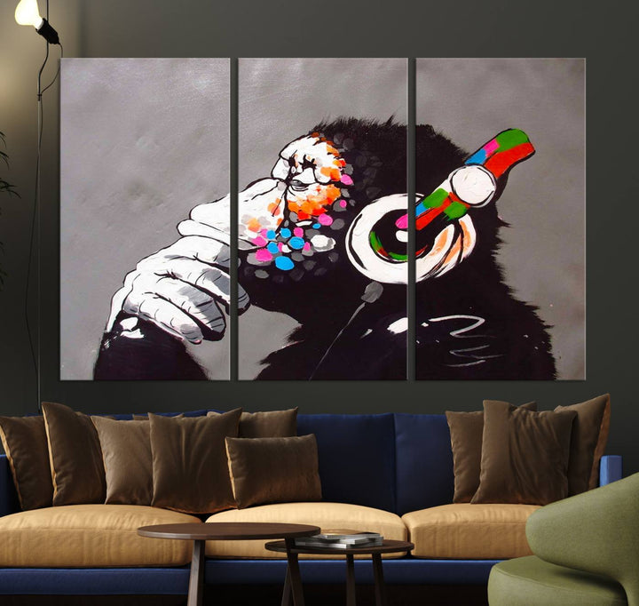 A vibrant triptych, the "DJ Monkey Listening to Music" wall art print, features a Banksy-inspired large canvas adorned with colorful modern pop art. This striking piece elegantly enhances the room with its dynamic and lively depiction.