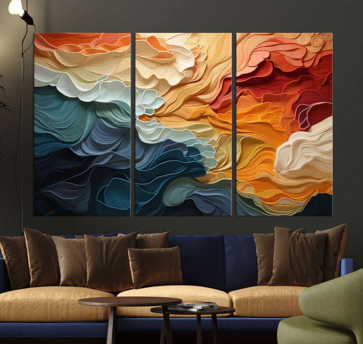 A Blue Orange Abstract Wave Wall Art Canvas Print adorns the wall. This colorful masterpiece is professionally hand-assembled to enhance any space.