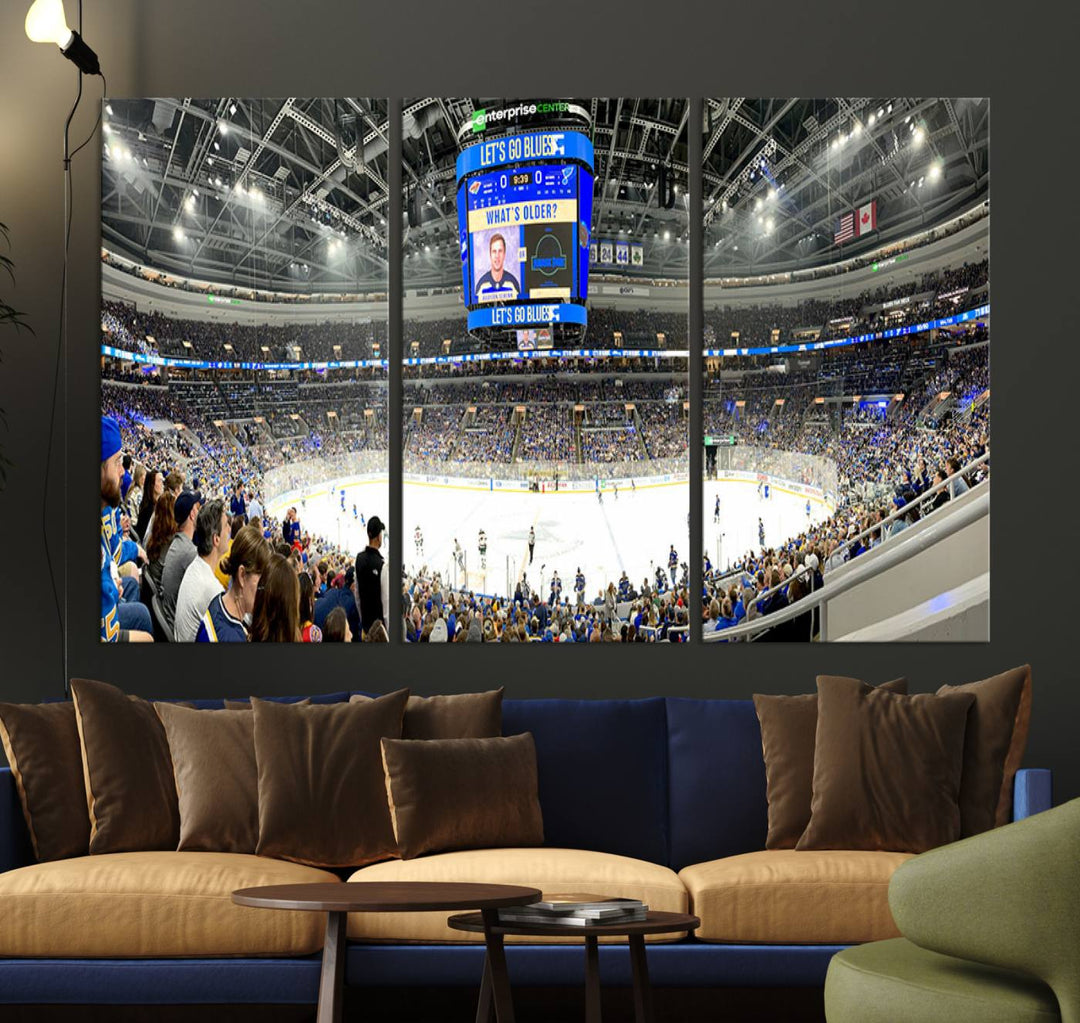 Wall art prints depicting the bustling scenes of the St. Louis Blues being cheered on by a full house at the Enterprise Center, beneath a large scoreboard.