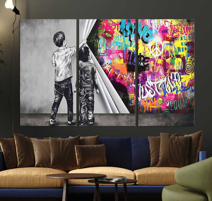 The Banksy Print - Street Art Canvas features a vibrant and bold image of two children lifting a curtain to reveal colorful graffiti. It's ready to hang, adding an urban modern decor vibe.