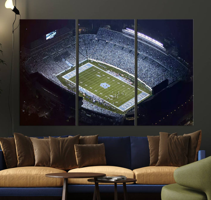 A University of North Carolina Tar Heels Football Team Print, showcasing Chapel Hill's Kenan Memorial Stadium, hangs in a modern dining room, adding a gallery-quality finish that enhances the entire space.