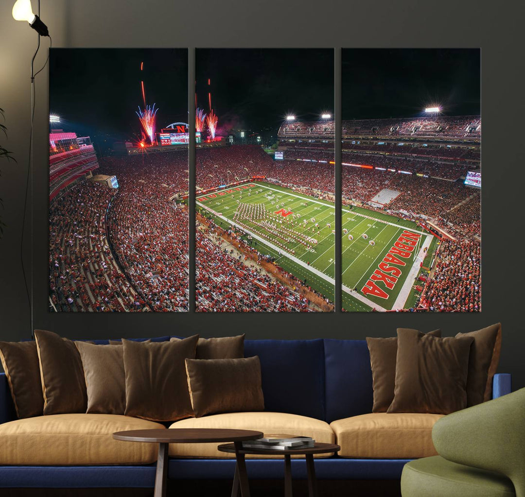 The University of Nebraska Cornhuskers Football Team Print, featuring Lincoln Memorial Stadium in a vibrant triptych canvas with fireworks above and a gallery-quality finish, is elegantly displayed.