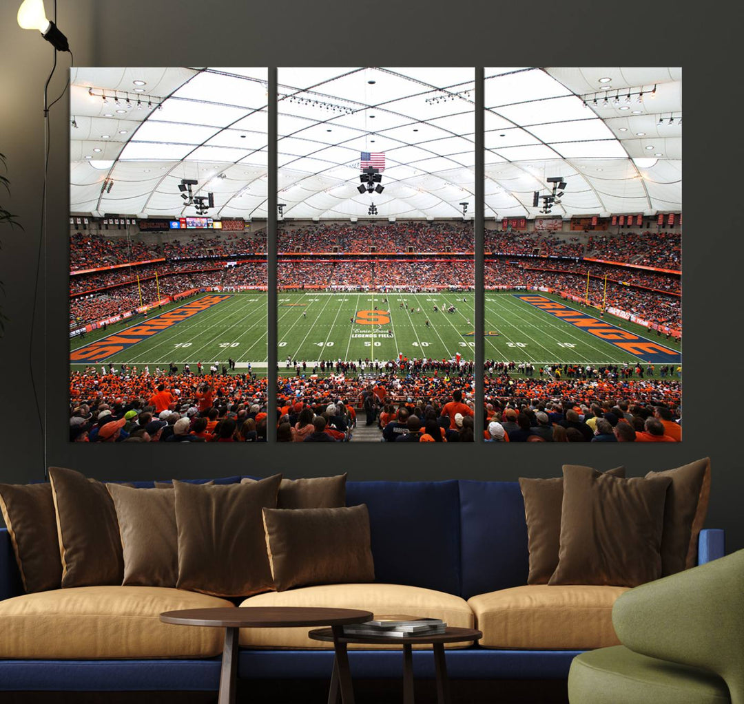 Fans fill the Syracuse JMA Wireless Dome, highlighted in orange and blue under a vaulted roof on this premium canvas print of the scene.