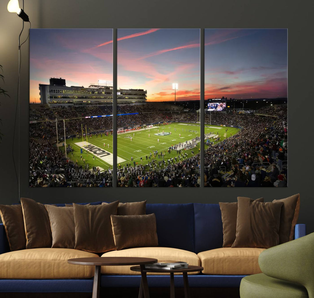 This wall art canvas print captures UCONN Huskies fans energizing a sunset scene at East Hartfords Pratt & Whitney Stadium.