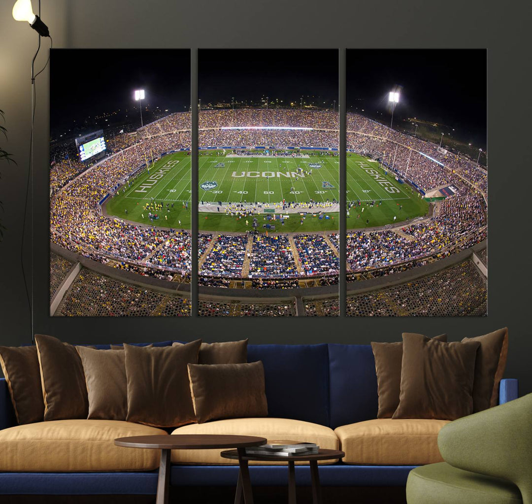 A large football stadium at night, featuring the UCONN Huskies, is depicted on the East Hartford Pratt & Whitney Stadium Wall Art Canvas Print.