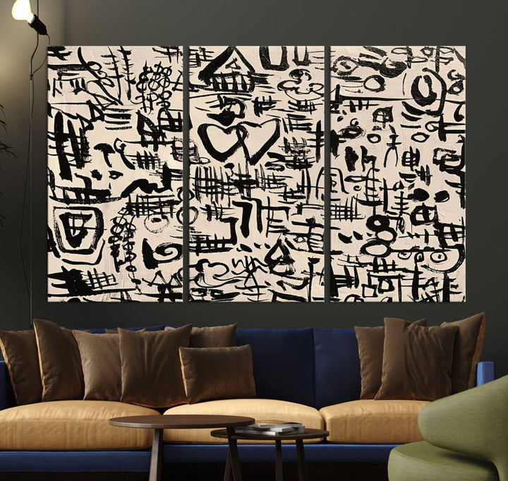 The Abstract Love and Chaos canvas is a museum-quality print featuring black symbols on a beige background, adorned with a heart and scribble design. It is framed to enhance its artistic appeal.