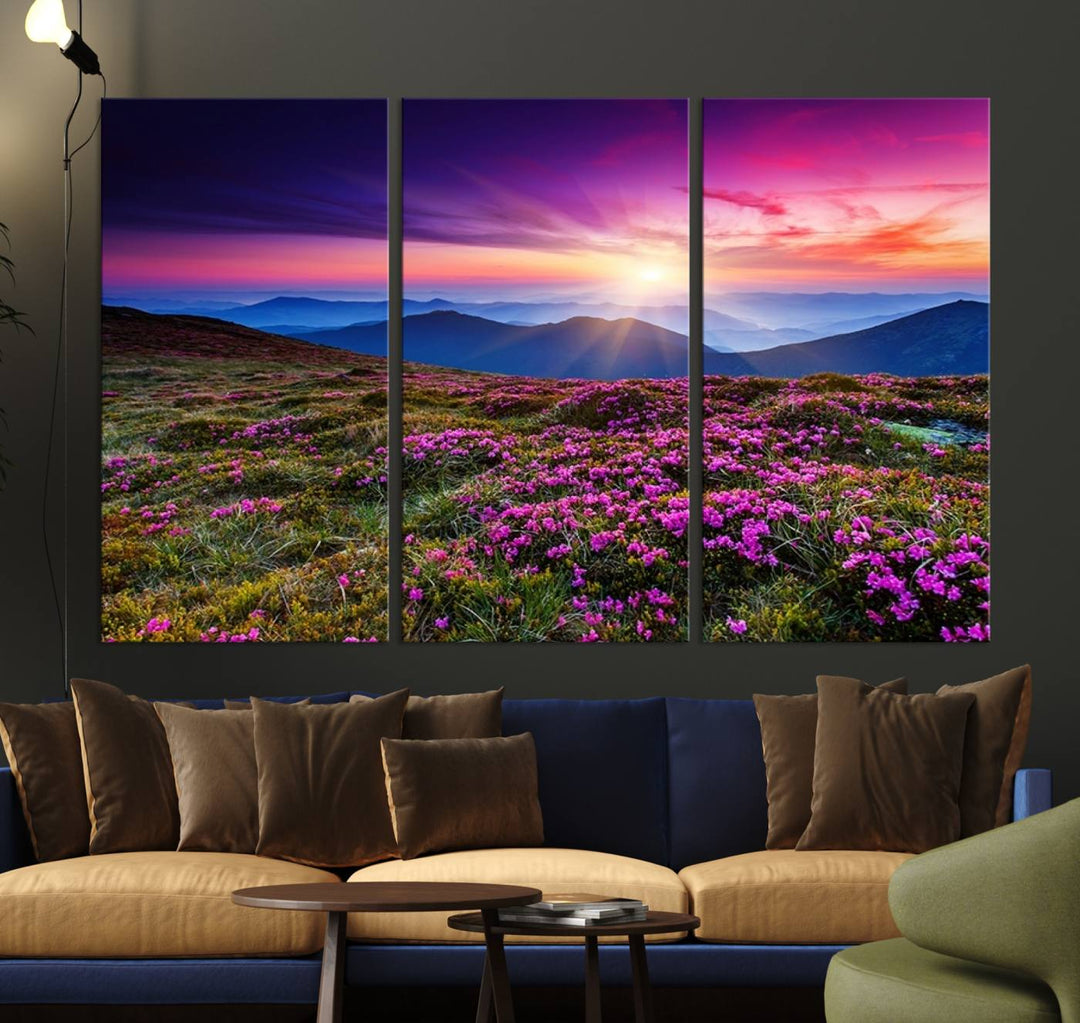 A 3-panel landscape photography canvas of a sunset over mountain meadows with purple wildflowers decorates the wall.