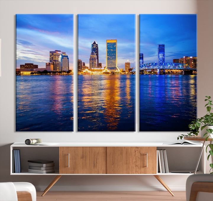 A cozy living room features the Jacksonville Wall Art Canvas Print, a large triptych crafted on museum-quality canvas that beautifully depicts the Jacksonville city skyline at sunset.