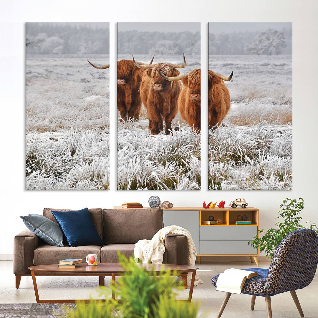 The Highland Cows in Snow canvas showcases three cattle in a frosty field.