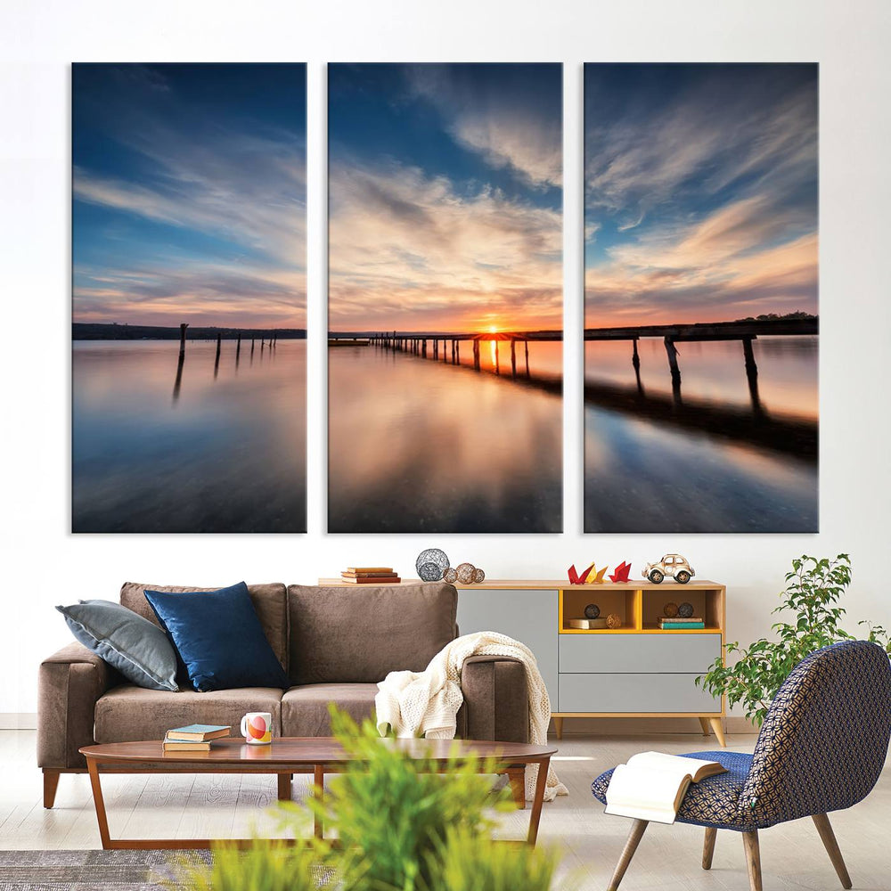 The Sunset Pier Canvas features a serene coastal landscape with vibrant hues under cloudy skies, ideal for modern decor.