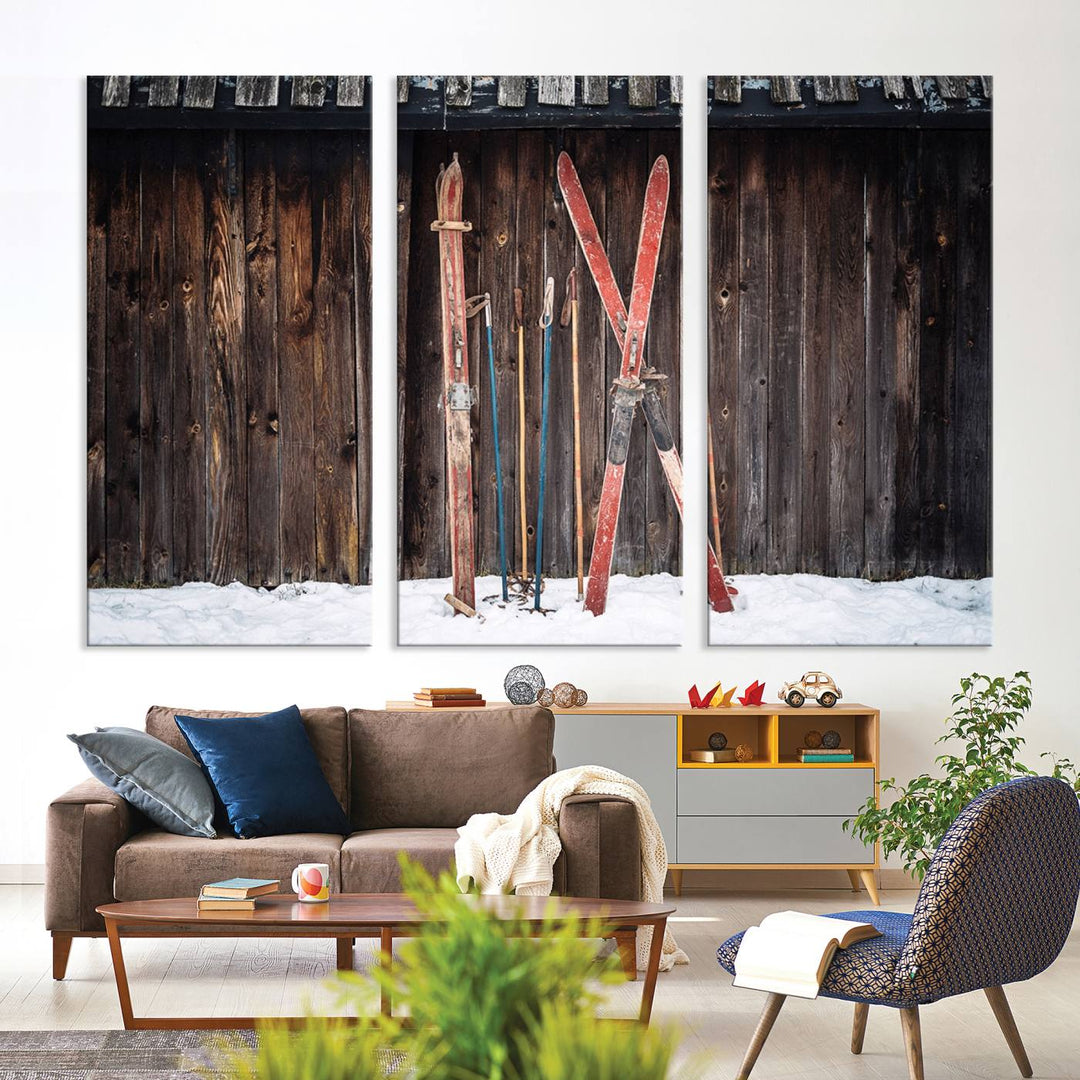 A canvas print titled Vintage Ski Gear Against Wooden Cabin Wall adorns the wall.