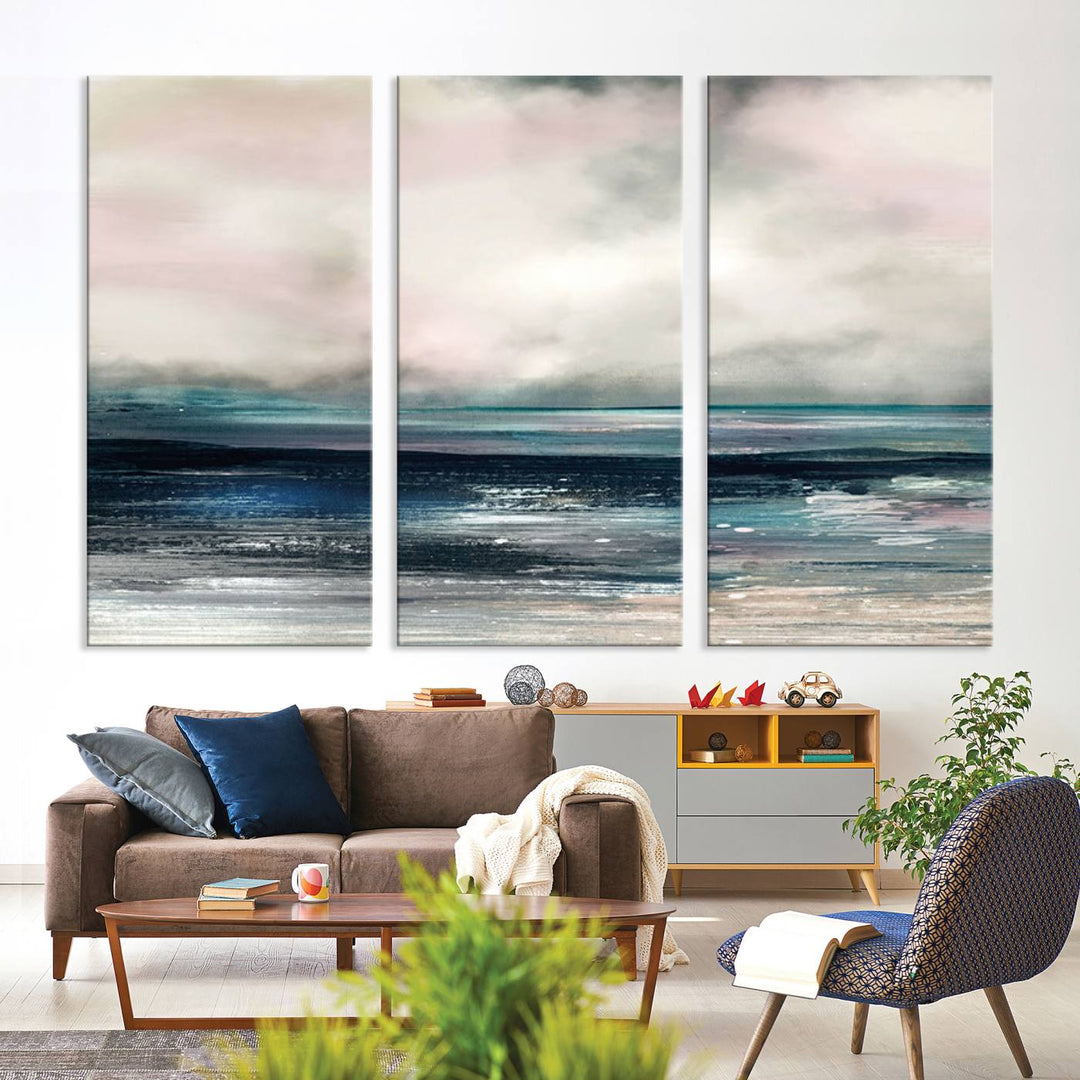 A contemporary abstract wall art canvas print in pastel pink, teal, and gray tones hangs on the wall.