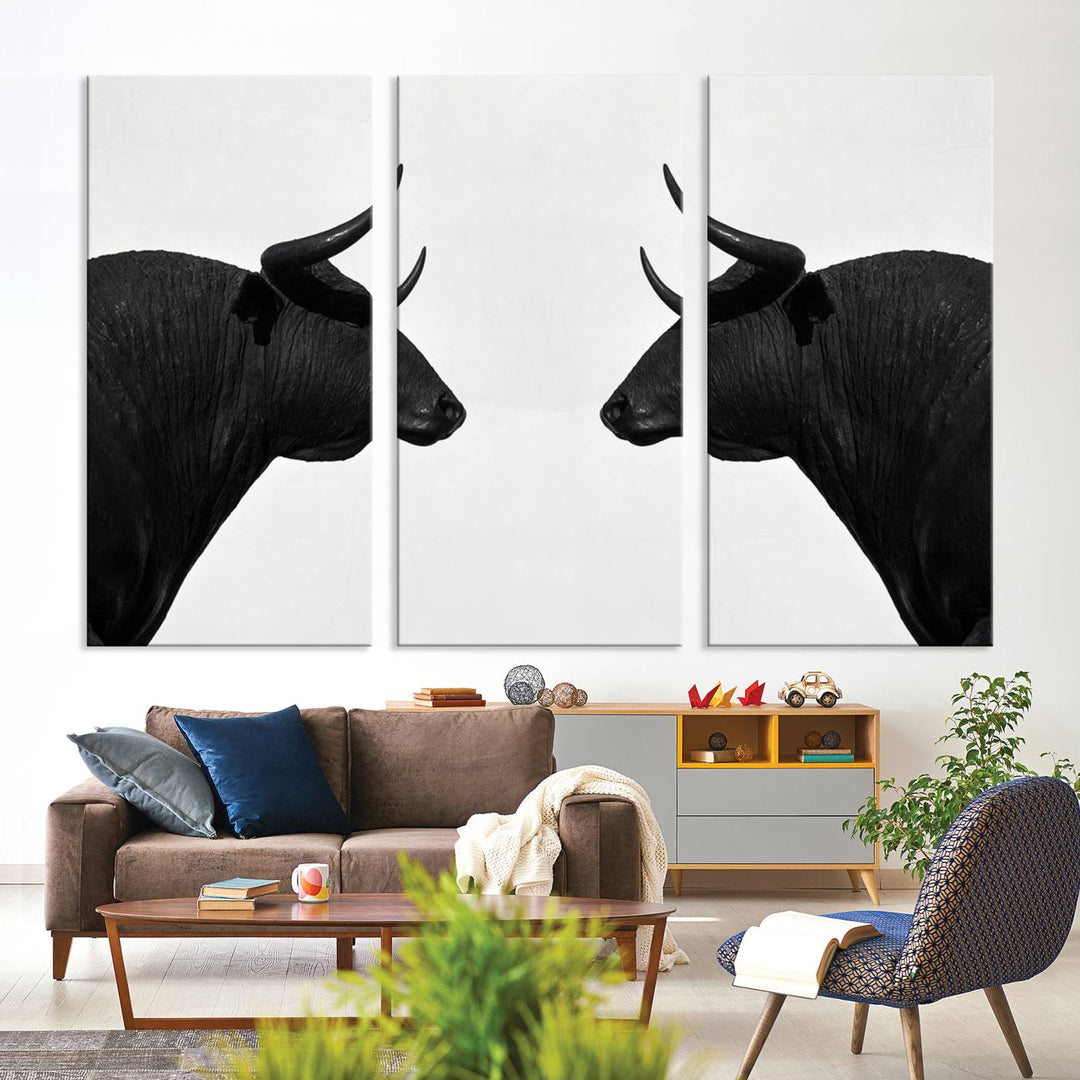 A framed canvas print featuring two black bull silhouettes, perfect for modern rustic decor.