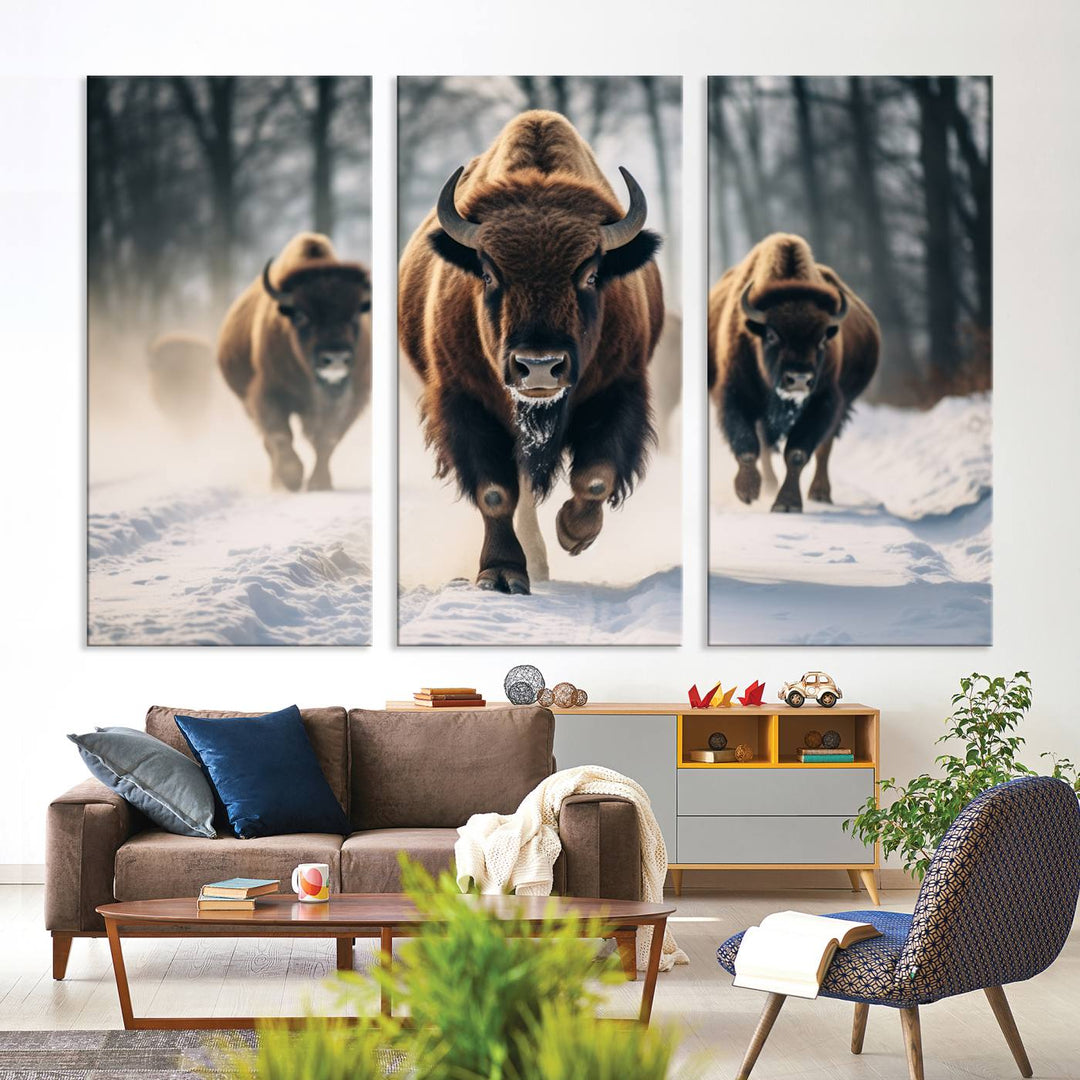 Wall art titled Cow Bighorn shows three bison running through snow in a forest.