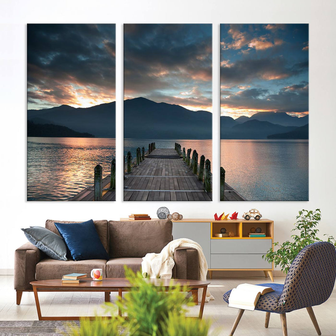 The Mountain Lake Wood Pier Canvas Wall Art depicts a serene lake and mountains, enhancing the beauty of any space.