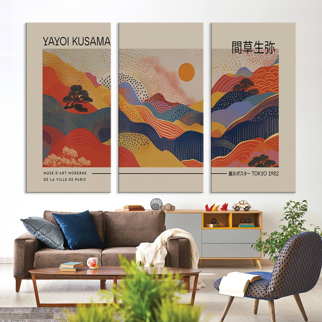 The Yayoi Kusama vibrant landscape canvas print featuring abstract mountains and a sun enhances the space with its modern aesthetic.