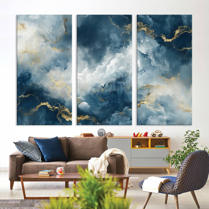 Modern living room featuring the Large Abstract Print - Luxe Blue and Gold Abstract Canvas Wall Art that showcases a bold cloudscape, perfect for modern home decor.