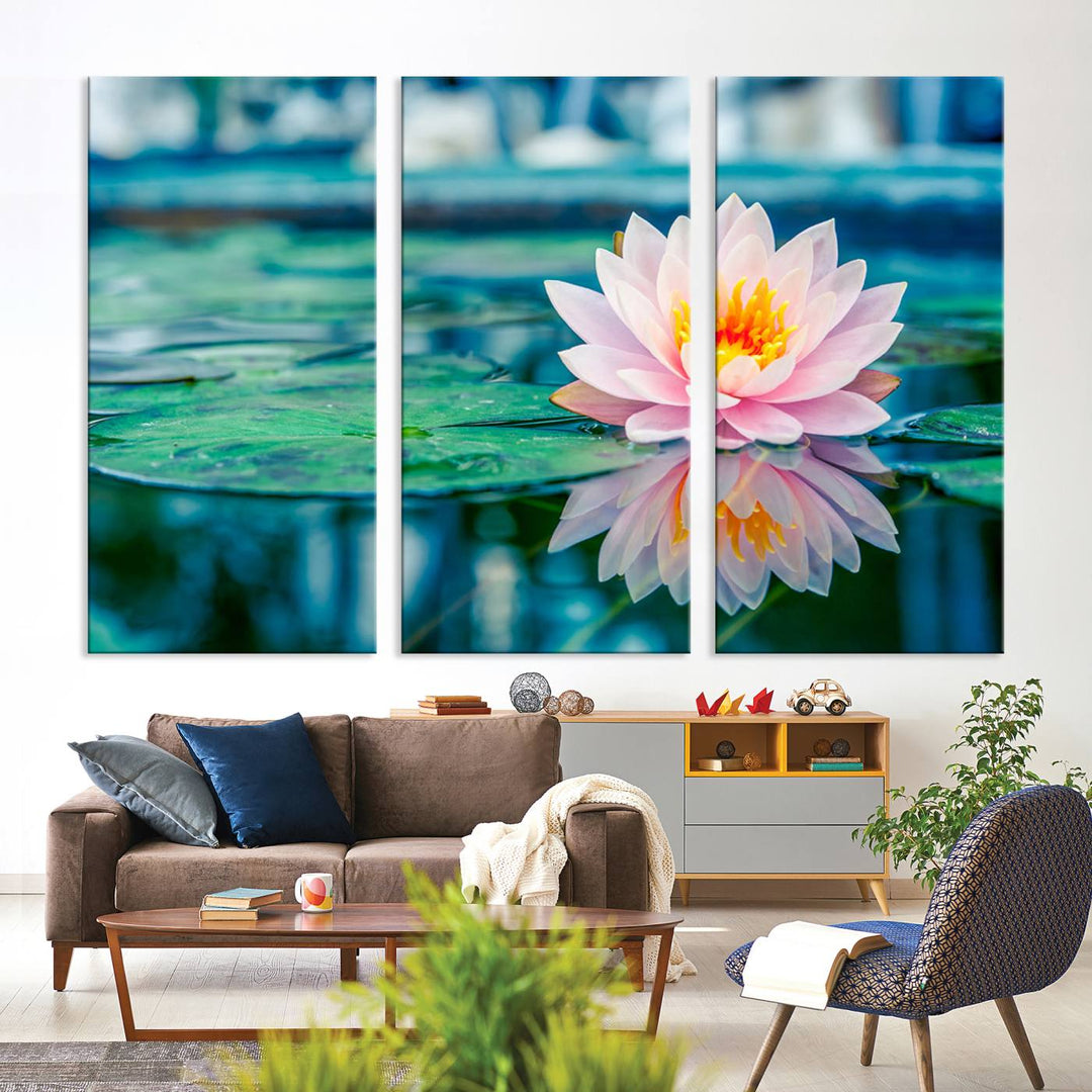 The Lotus Flower Canvas Print showcases a pink water lily with a yellow center gracefully floating on a calm pond.