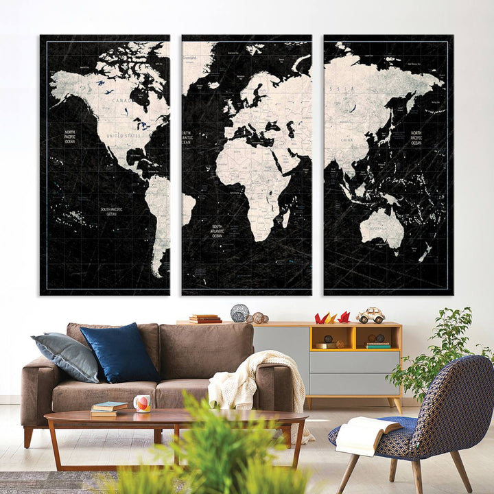 A bold global style framed black and white world map canvas print, presented in three panels, perfect for modern home or office decor.